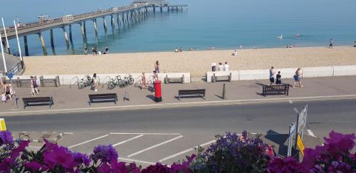 a view of a beach with people and a pier at Waterfront Hotel in Deal