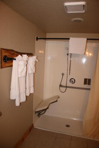 a bathroom with a shower with white towels at The Trailhead in South Lake Tahoe