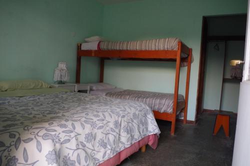 a bedroom with two bunk beds and a bed at Hostel Los Cormoranes in Ushuaia