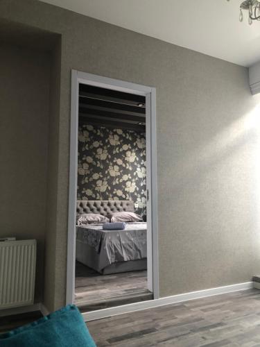 a bedroom with a door leading to a bed at Dona Palace Apartments in Tbilisi City