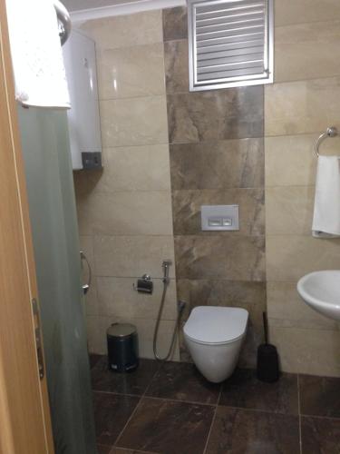 a bathroom with a toilet and a sink at Seyran Seaside Apartments- 2-garden floor in Trabzon
