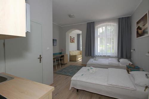 Postel nebo postele na pokoji v ubytování Willa Park Apartamenty