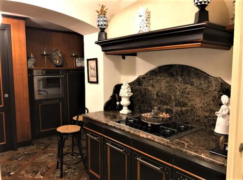 a kitchen with a stove and a counter top at The queen's house in Agrigento