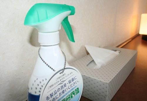 a bottle of hand cleaner sitting next to a box at Royal Hotel Odate in Odate