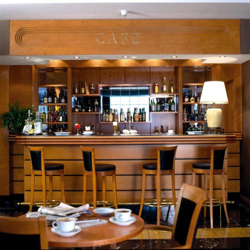 a bar with chairs and tables in a restaurant at Ramada by Wyndham Naples in Naples
