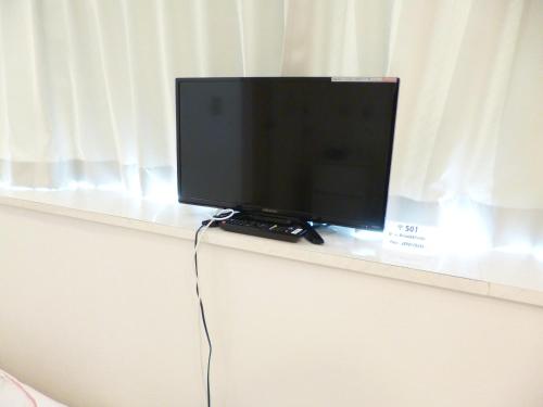 a flat screen tv sitting on top of a shelf at OUCHI HOTEL Yokogawa in Hiroshima