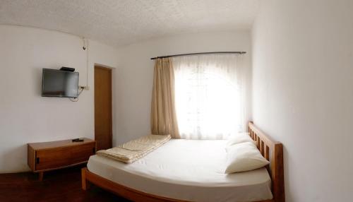 Cama o camas de una habitación en Tani Jiwo Hostel