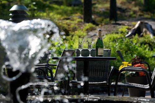 a table with two bottles of wine on it at Hotel Korpilampi in Espoo