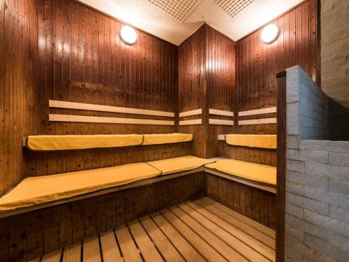 a sauna with wooden walls and benches in a room at Premier Hotel-CABIN-Sapporo in Sapporo