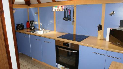 a kitchen with blue cabinets and a counter top at Waldeck in Frankenau