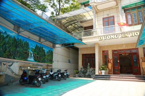 a group of motorcycles parked outside of a building at Duong Ha Hotel in Cao Bằng