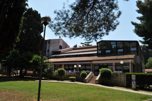 a building with a street light in front of it at Hotel Flores in Poreč