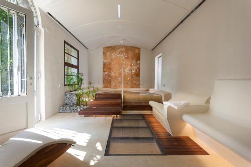 a living room with a staircase and a couch at Il Villino Hotel & SPA in Santarcangelo di Romagna