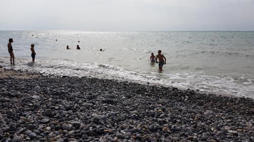 a group of people in the water at the beach at Appartement centre village vue mer - Relais Fleuri in Ault