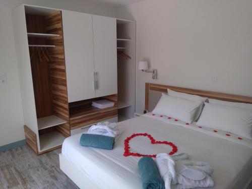 ein Schlafzimmer mit einem Bett mit einem Herz aus Handtüchern in der Unterkunft Océan d'amour & spa in Saint-Vivien