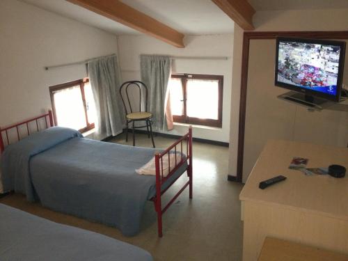 a bedroom with a bed and a flat screen tv at Hotel Rivamare in Massignano