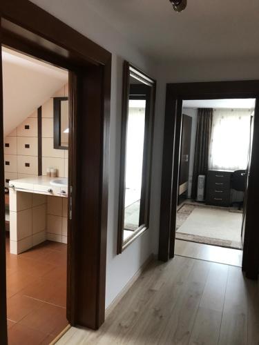a bathroom with two mirrors and a sink in a room at Dor de munte in Borşa