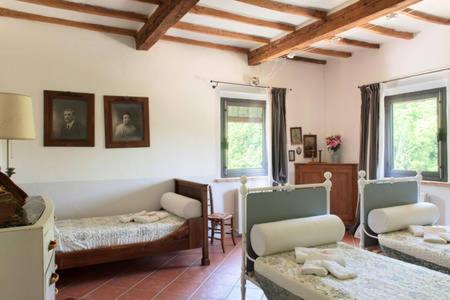 a living room with a bed and chairs in a room at Molino di Amarrante in Montaione