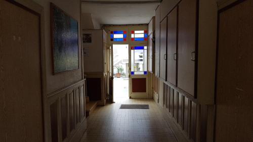 an empty hallway with a door to a room at Appartement centre village vue mer - Relais Fleuri in Ault