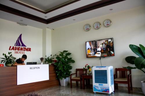 a lobby of a hotel with a person sitting at a desk at Lavender Hotel in Dong Hoi