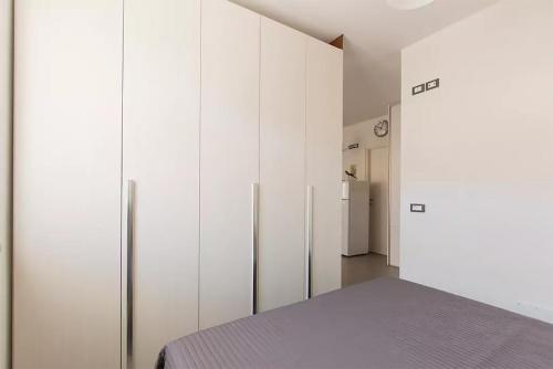 um quarto com armários brancos e um frigorífico em Casa dei Marmi - in Toscana 10 min dal mare em Massa