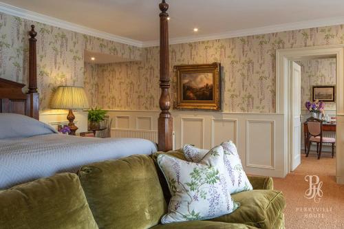 a bedroom with a bed and a couch at Perryville House in Kinsale