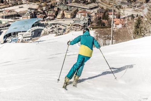 a person is skiing down a snow covered slope at TUI BLUE Schladming in Schladming