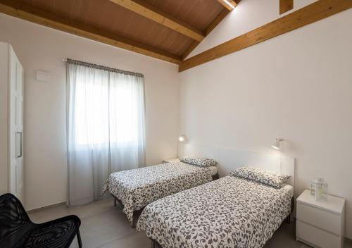 Un pat sau paturi într-o cameră la Villa Milli