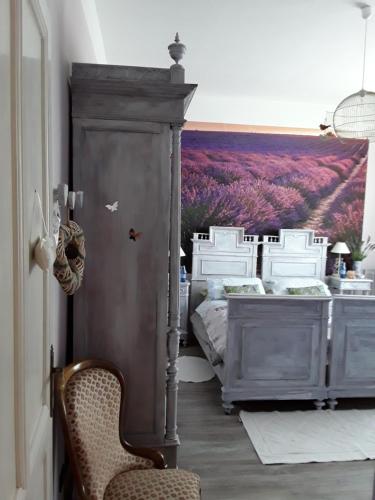 a bedroom with two beds and a large window at B&B Cà dal Busc in Sostegno