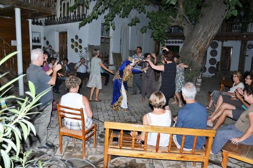 a bride and groom dancing in front of a group of people at Hotel Legende in Samarkand