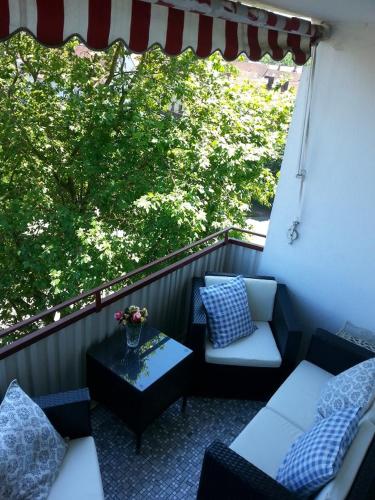 a balcony with two couches and a table with a view at Seesterne Residenz in Konstanz