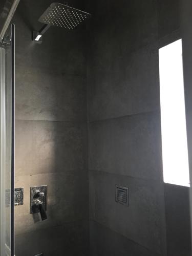 a bathroom with a shower and a window at Micasa Hostels in Puducherry