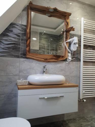 a bathroom with a sink and a mirror at Rustic Inn River in Plitvička Jezera