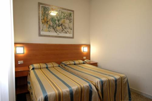 Postel nebo postele na pokoji v ubytování Hotel Moderno