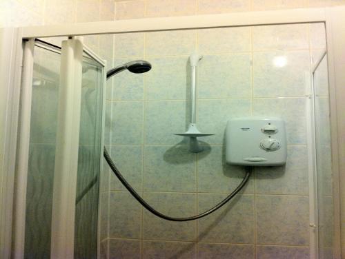 a shower with a soap dispenser in a bathroom at City Inn Express Hotel in London