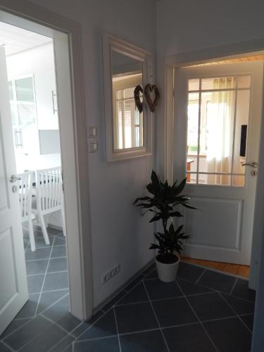 a hallway with a potted plant on a tile floor at Ferienhaus Renate in Leer