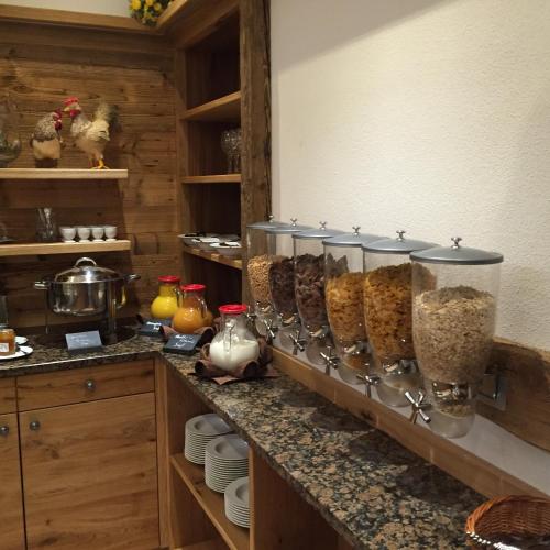 a kitchen counter with many containers of food at Gasthaus Georg Ludwig Maising in Pöcking