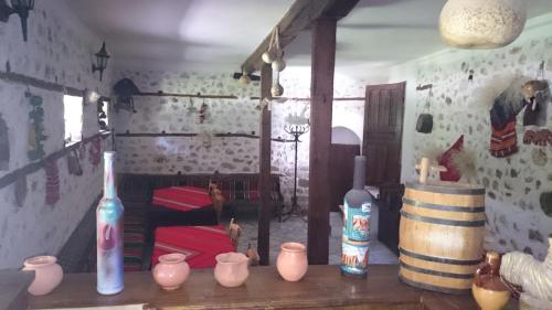 una habitación con botellas y jarrones en una mesa en Узуновата къща en Melnik