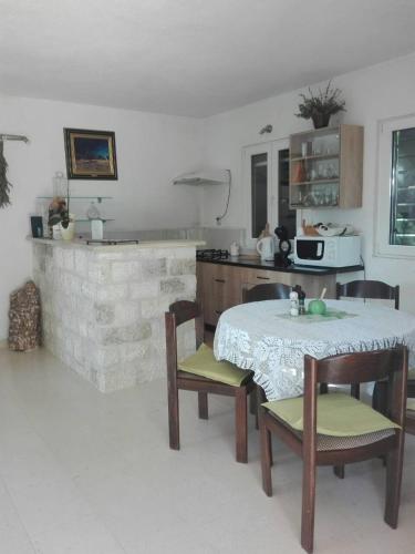 a kitchen with a table and chairs in a room at Villa Ujoli in Splitska