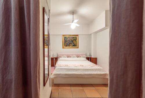 a bedroom with a bed and a mirror at Ciclope's House with Mini Spa and amazing view in Aci Catena