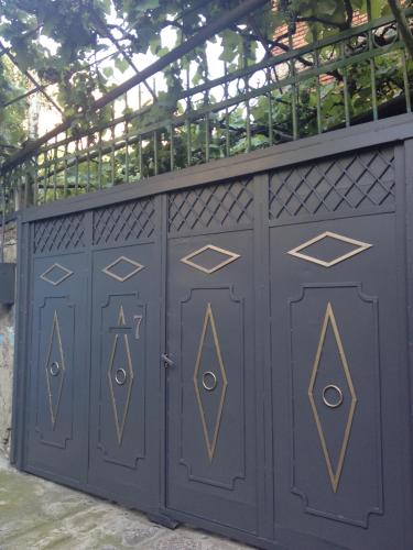 a pair of blue garage doors with a metal roof at Nika7 in Tbilisi City