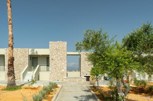 a house with a tree in front of it at Achilles Hill Hotel in Methoni