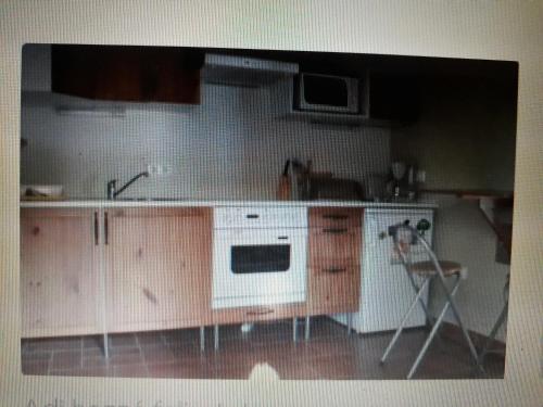 a kitchen with a sink and a stove at Kőház apartman in Balatonfüred