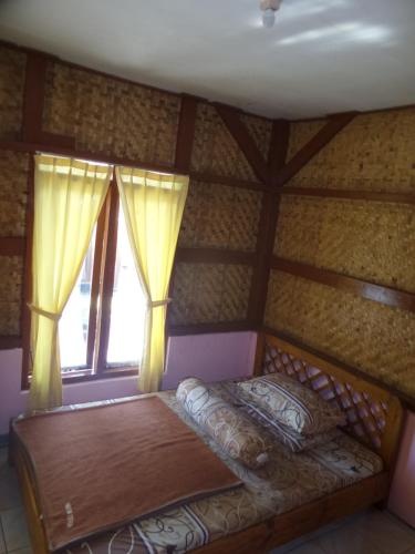a bedroom with a bed in a room with a window at Pondok Stevia Ciwidey in Ciwidey
