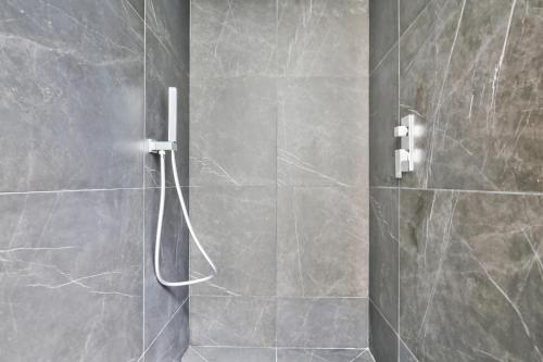 a bathroom with a shower with a glass door at 69 - Authentic Parisian Home in Paris