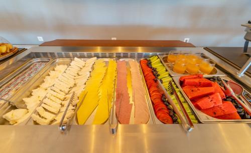 a tray of different types of food on a buffet at Achilles Hill Hotel in Methoni