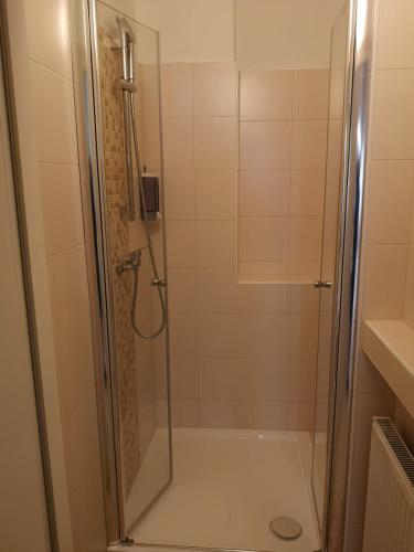 a shower with a glass door in a bathroom at CH-Hostel in Vienna