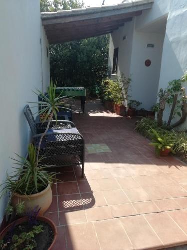 a patio with two chairs and a table and plants at Casa Gelsomino in Carlentini