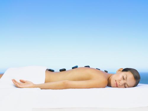 a woman laying on a bed at Samsara Cliff Resort in Negril