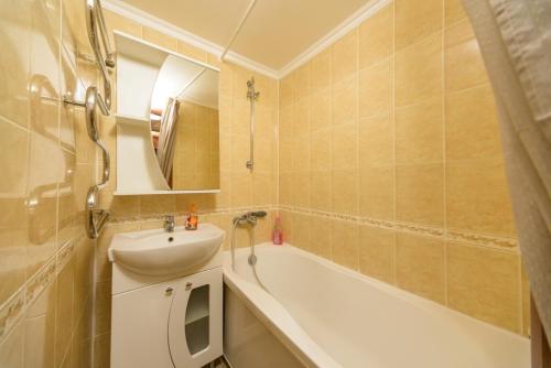 a bathroom with a sink and a bath tub at Prospekt Geroiv Stalingradu Apartments in Kyiv